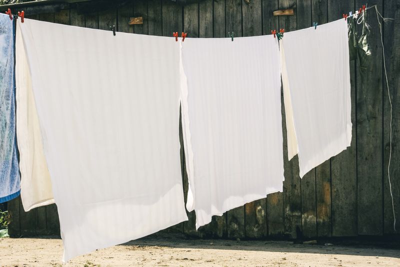 Washed bed sheets on the washing line drying.