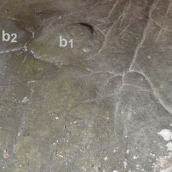 lines etched into a cave floor, believed to represent a map (left); blocks of moss-covered sandstone outside La Ségognole 3 (right)