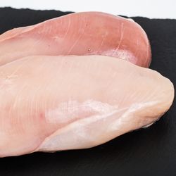 Chicken breast on a board with white stripes on them
