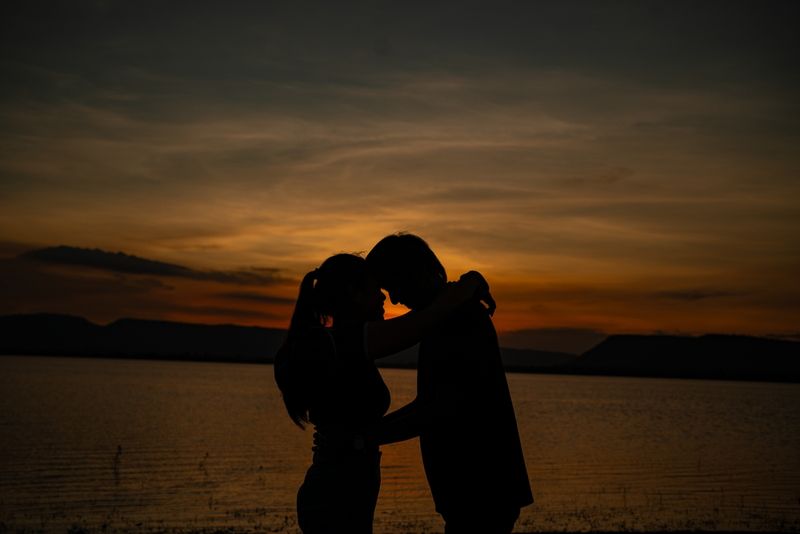 Couple on a camping trip next to a body of water.