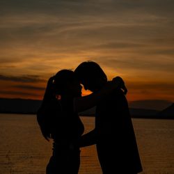 Couple on a camping trip next to a body of water.