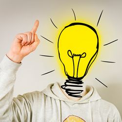 person pointing to the ceiling with their head replaced with a drawing of a yellow lightbulb to represent a flash of inspiration