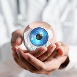 close up of hands holding a digitally illustrated eye