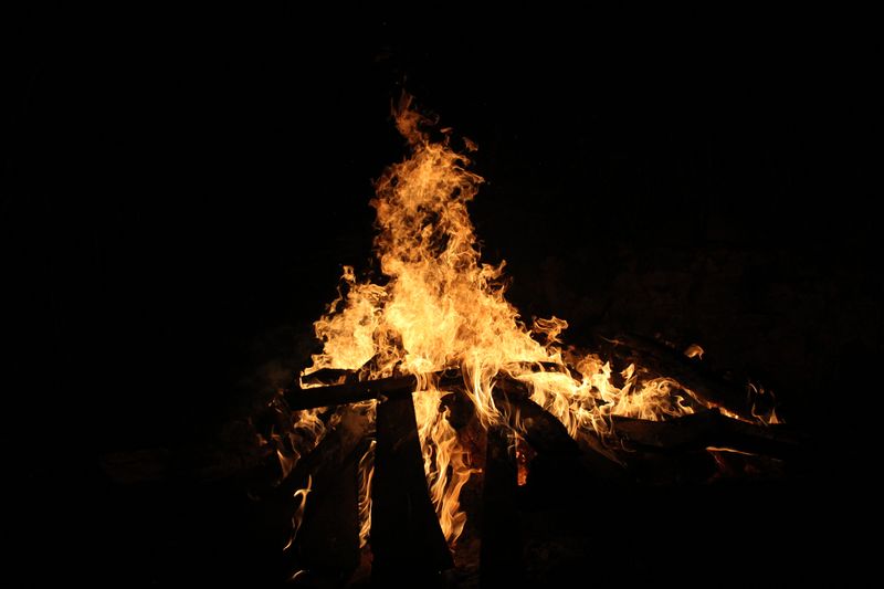 orange flames of a campfire against a black background