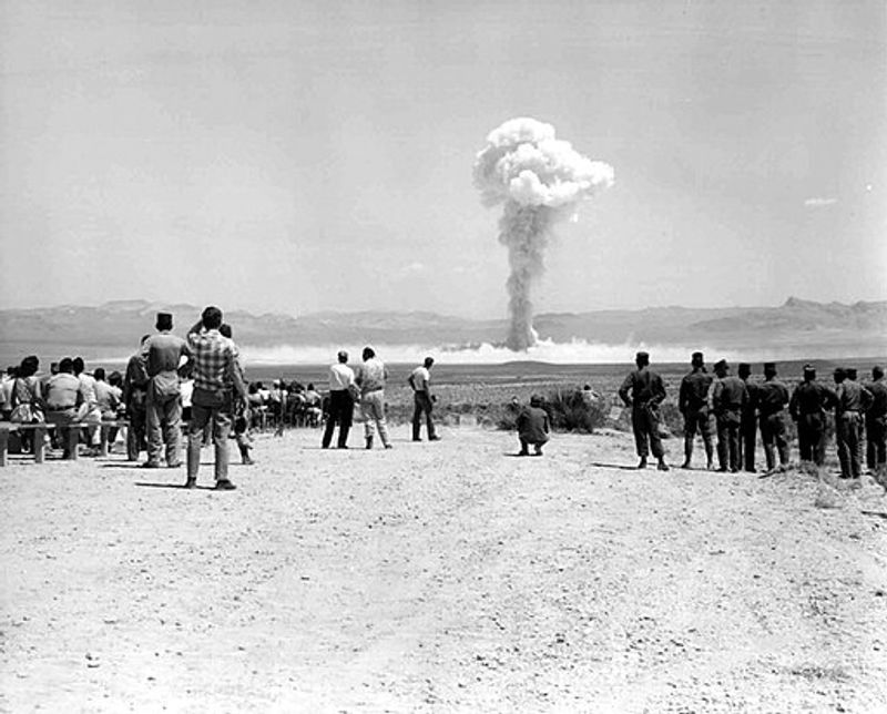 Folks watching an American nuclear bomb drop at the Nevada Test Site on July 14, 1962