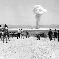 Folks watching an American nuclear bomb drop at the Nevada Test Site on July 14, 1962