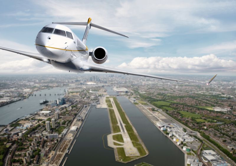 A digitally edited photo showing the Global 8,000 flying away from London. The jet is facing the viewer and below it is the river Thames and key features of the London cityscape. 