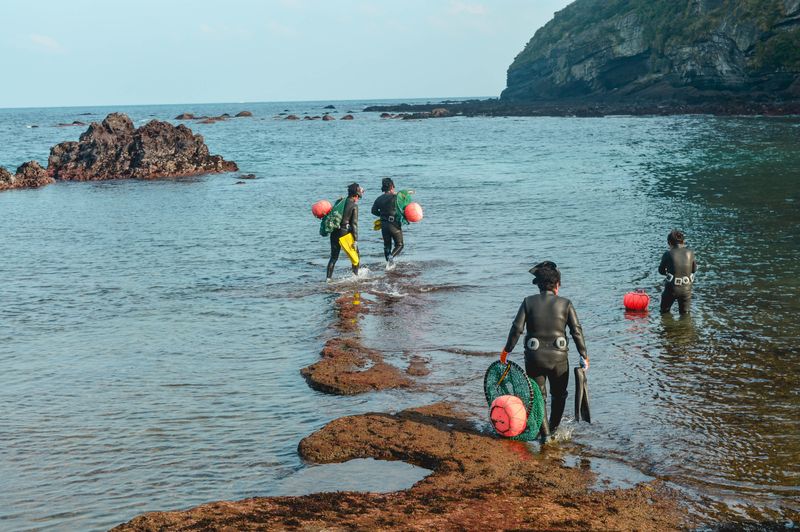A group of Haenyeo get ready for a dive near Songsan Ilchulbong on Jeju Island, South Korea.
