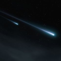 Two meteor trails against the background of stars at night