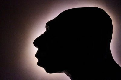  Neanderthal head in a silhouette profile.