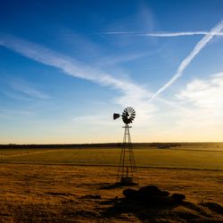 A picturesque field in rural Oklahoma, with sunset in distance