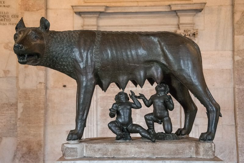 statue of infant romulus and remus suckling at a female wolf
