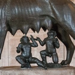 statue of infant romulus and remus suckling at a female wolf