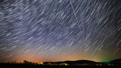 star trail view of the sky with the occasional straight bright line caused by satelites