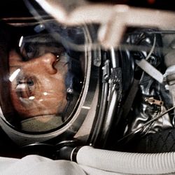Shepard in his space suit is seen among tubes.