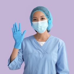 Surgeon wearing scrubs and waving