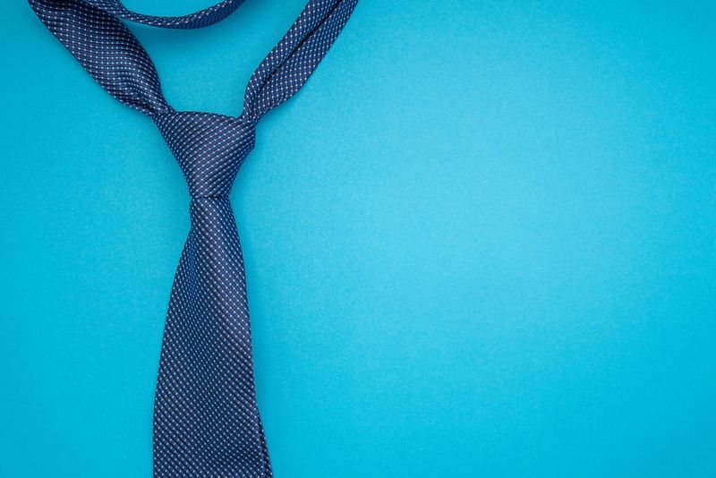 A tie on a table with a blue background.