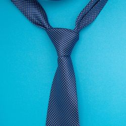 A tie on a table with a blue background.