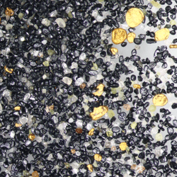 tiny flecks of gold among other minerals in fine sand on new zealand beaches