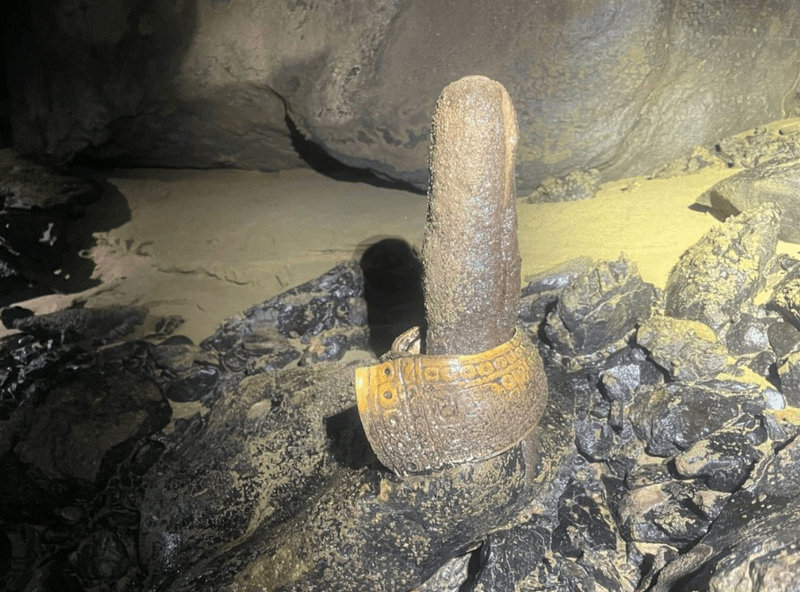 An ancient bracelet was consciously placed on top of this phallic-looking cave stalagmite.