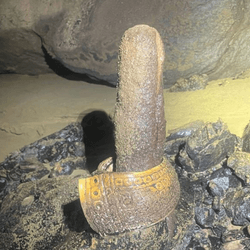 An ancient bracelet was consciously placed on top of this phallic-looking cave stalagmite.