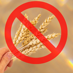 hand holding sheaves of wheat with a big red circle with a line through it over the top