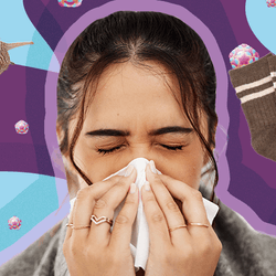 woman blowing her nose wrapped in a blanket at the centre of a collage of images including a snail, sliced red onion, brown socks, and cold virus particles on a background of purple and blue abstract shapes