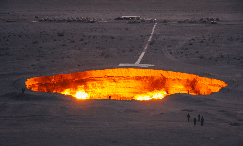 A flaming pit of orange flames at Darvaza Crater in Karakum Desert, Turkmenistan. 