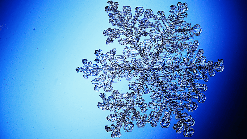 a large snow crystal on a blue background