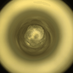 the camera is looking down a circular canister. at the end a silvery ragged pebble