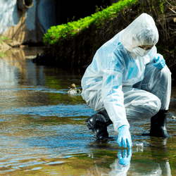 Scientists in hazmat suit takes water samples from a river, illustrating the environment contamination of PFAS