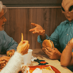 A family talking and having conservation with an alien in a shirt