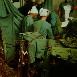 team of scientists doing open heart surgery in 1960s